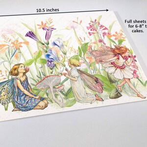 The image is a watercolor painting depicting three fairy characters surrounded by flowers and plants. The painting is approximately 10.5 inches wide and 8.5 inches tall.