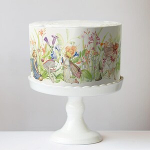 A white cake stand with a decorative floral pattern on it.