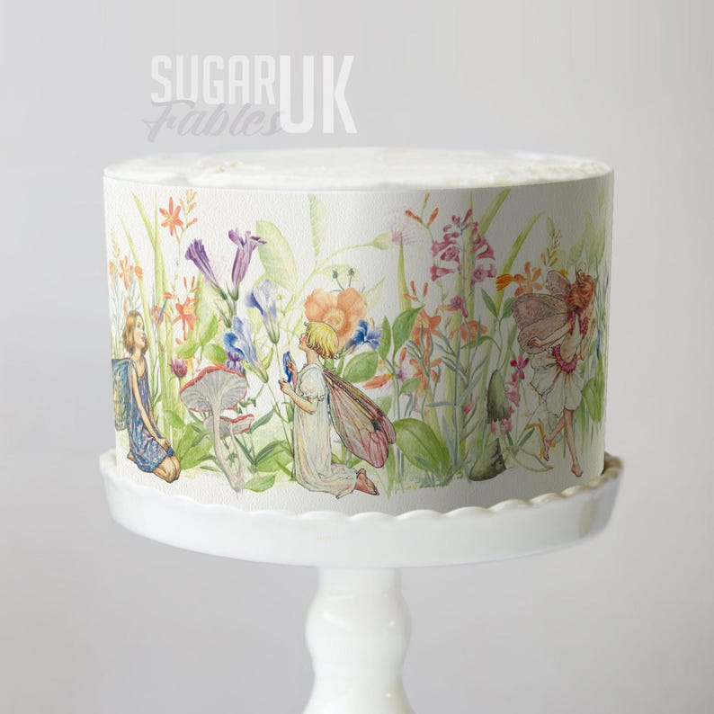 A cake decorated with a whimsical, fairy-themed design featuring colorful flowers and fairies.