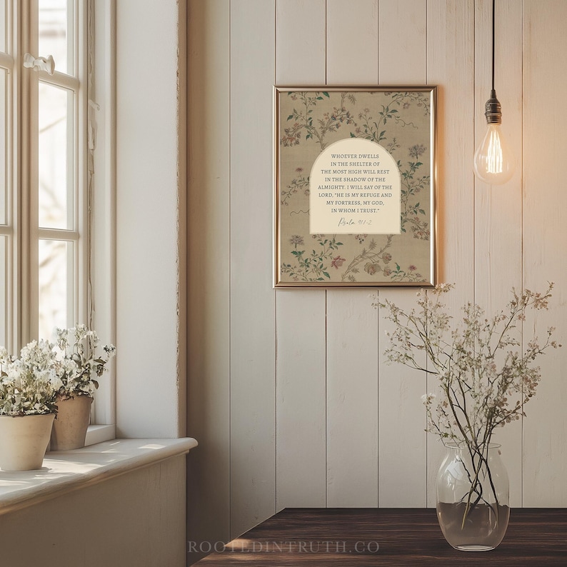 a serene indoor setting with a framed quote on the wall, a vase of flowers on a windowsill, and a light fixture hanging from the ceiling.