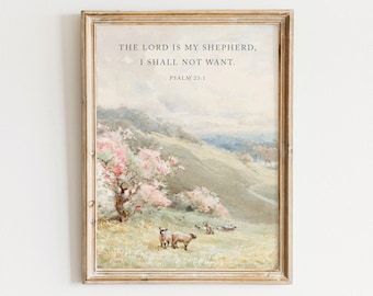 May include: A framed wall art print featuring a pastoral landscape with rolling hills, a blooming pink tree, and sheep grazing in a field. The text reads: THE LORD IS MY SHEPHERD, I SHALL NOT WANT. PSALM 23:1. The frame is a light wood color.