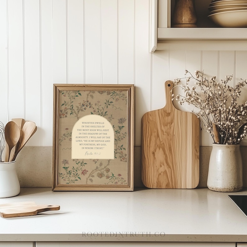 a framed print with a floral design, a wooden cutting board, a vase with flowers, and a shelf with various kitchen items.