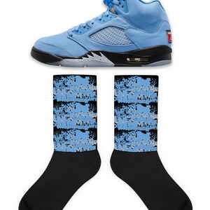 May include: A pair of light blue and black sneakers with a white sole. The sneakers are paired with a pair of black socks with a light blue and gray pattern.