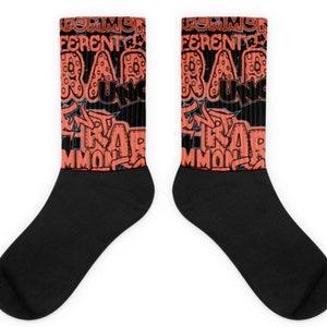 May include: A pair of black socks with a colorful design featuring the words "Common", "Different", "Rare", and "Uncommon" in a graffiti-style font. The words are in a bright orange color.