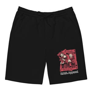 Può includere: Pantaloncini neri con vita con coulisse e tasche. I pantaloncini presentano una grafica di due carte da gioco con un design rosso e nero. Il testo "FAKE LOVE" e "TRUST NO ONE" sono visibili sulle carte. Il testo "R.U.D. Apparel" è stampato.