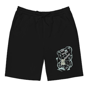 Puede incluir: Pantalones cortos negros con cintura con cordón y bolsillos. Los pantalones cortos presentan un gráfico azul claro de un oso de peluche sosteniendo dinero, con las palabras "RARE UNCOMMON DIFFERENT" en una fuente estilizada.