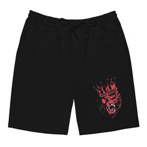 May include: Black athletic shorts with a drawstring waist and side pockets. A red graphic of a lion wearing a crown is printed on the lower right leg. The text "R.O.D. APPAREL" is above the lion's head.