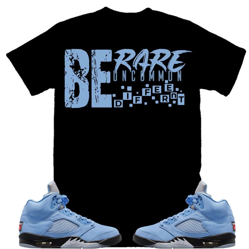 May include: A black t-shirt with the text "BE RARE UNCOMMON" in light blue. The text is broken up into individual letters with a pixelated effect. Two light blue sneakers with black accents are shown below the t-shirt.