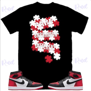 May include: Black t-shirt with a puzzle design in red and white, featuring the words "Hate Uncommon, See The Difference". The image also shows a pair of red, black, and white high-top sneakers.