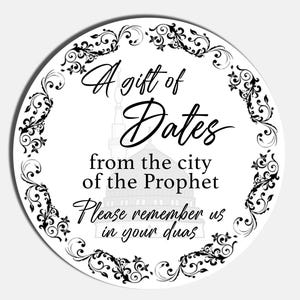May include: A round sticker with a white background, black text, and a decorative border. The text says "A gift of Dates from the city of the Prophet. Please remember us in your duas."