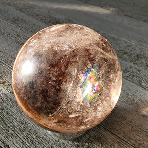 Stunning garden quartz lodalite sphere with beautiful rainbows.