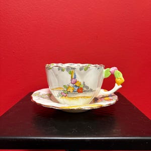 Lovely paragon cup and saucer —  flower handle - great condition - see photos