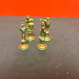 Lovely antique set of four brass Dickens character pipe  tampers — wonderful set in great condition and 2. 5 inches high each.