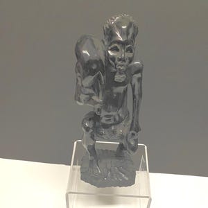 A Foot tall vintage African Ebony wood statue of a man carrying an animal — hunter — well carved — 900 grams