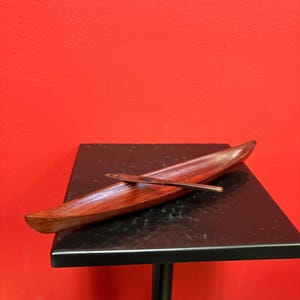 Lovely 10 inch  indigenous wooden model  canoe — simple and elegant with one paddle