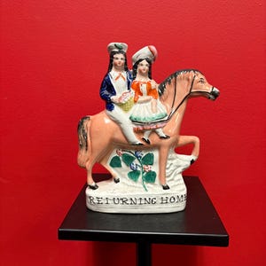 Beautiful 8  inch Staffordshire statue of a couple on Horse — returning home— good condition -B