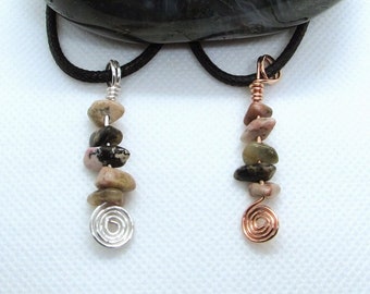 May include: Two necklaces with a silver and copper wire wrapped spiral at the bottom. Each necklace has a series of five small, irregularly shaped, multi-colored stones.
