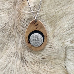 A handmade Sami Duodji pendant in masur birch and tin wire, 1970s.