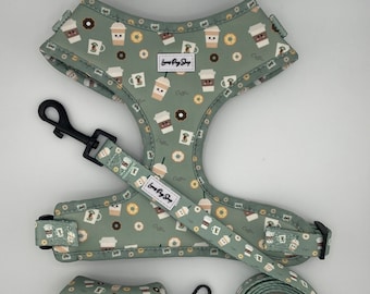 May include: A green dog harness, leash, and poop bag holder with a coffee cup and donut pattern. The harness and leash have the text "Love Pug Shop" on them. The poop bag holder has the text "Love Pug Shop" on it.