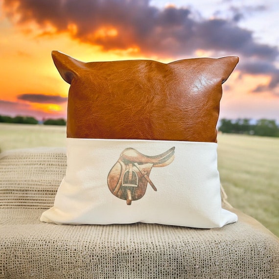 The Boho Collection Two Tone Cognac Leather white canvas throw pillow with equestrian motif (saddle,irons,boots,bit,headstall,jockey)Faux