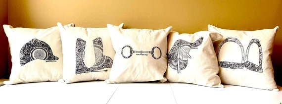 The Chin Up Collection Throw Pillows featuring a saddle, bit, irons, boots & helmet motif on cover only linen blend.