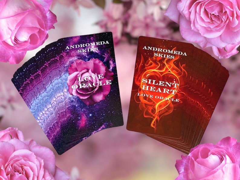 Puede incluir: Dos barajas de cartas de or&aacute;culo con un fondo de galaxia p&uacute;rpura y rosa y un dise&ntilde;o de rosa. El texto en las cartas dice "Andromeda Skies Love Oracle" y "Silent Heart Love Oracle".