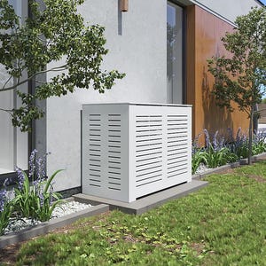 May include: White outdoor air conditioning unit with a slatted cover, situated on a concrete base next to a house with a brown wooden wall. The unit is surrounded by green grass and landscaping.