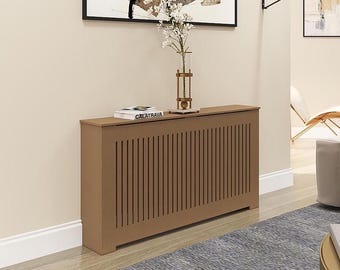 May include: A brown wooden radiator cover with vertical slats. The cover has a book titled "Calatrava" on top of it.