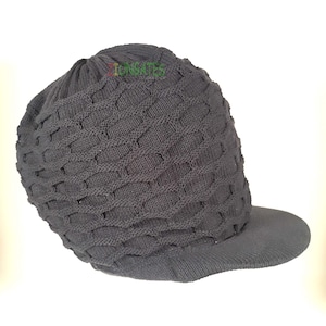May include: A black knitted beanie with a brim. The beanie has a diamond pattern and is folded down.
