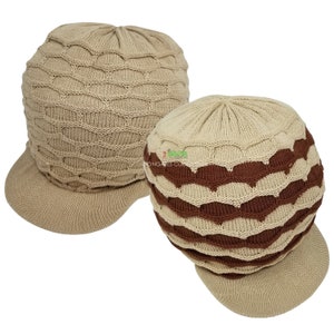 May include: Two knitted hats with a brim. One hat is beige with a wavy pattern. The other hat is beige with brown wavy stripes.