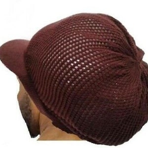 May include: A brown knitted beanie with a mesh top and a wide brim. The beanie has a relaxed, slouchy fit.