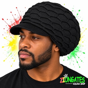May include: A black knit cap with a visor and a textured honeycomb pattern. The cap features a structured brim and a soft, rounded crown. The logo ZIONGATES CULCHA SHOP with a small crown icon is visible in the bottom right corner of the image.