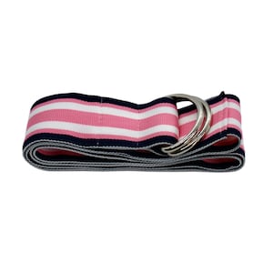 May include: A folded belt with pink, white, and navy blue horizontal stripes. The belt features a silver-colored double D-ring buckle. The design is simple and classic, suitable for casual wear.