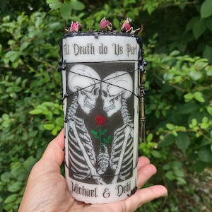 May include: A black and white candle with a skeletal couple embracing, a red rose, and the text "Till Death do Us Part" and "Michael & Deli" on a white background.