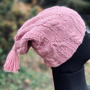 Muted-pink handknit hat with complex yet rustic cables. Women's small, medium. Artisanal Blue-faced Leicester wool. Hiking ready. Cozy warm.