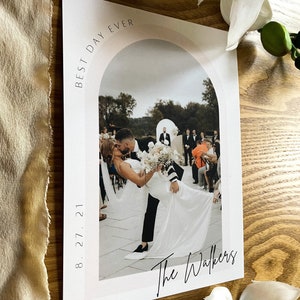 May include: A wedding photo with the couple kissing under an archway. The photo is framed with a white border and has the text "Best Day Ever" and "The Walkers" written on it. The date "8.27.21" is also included.