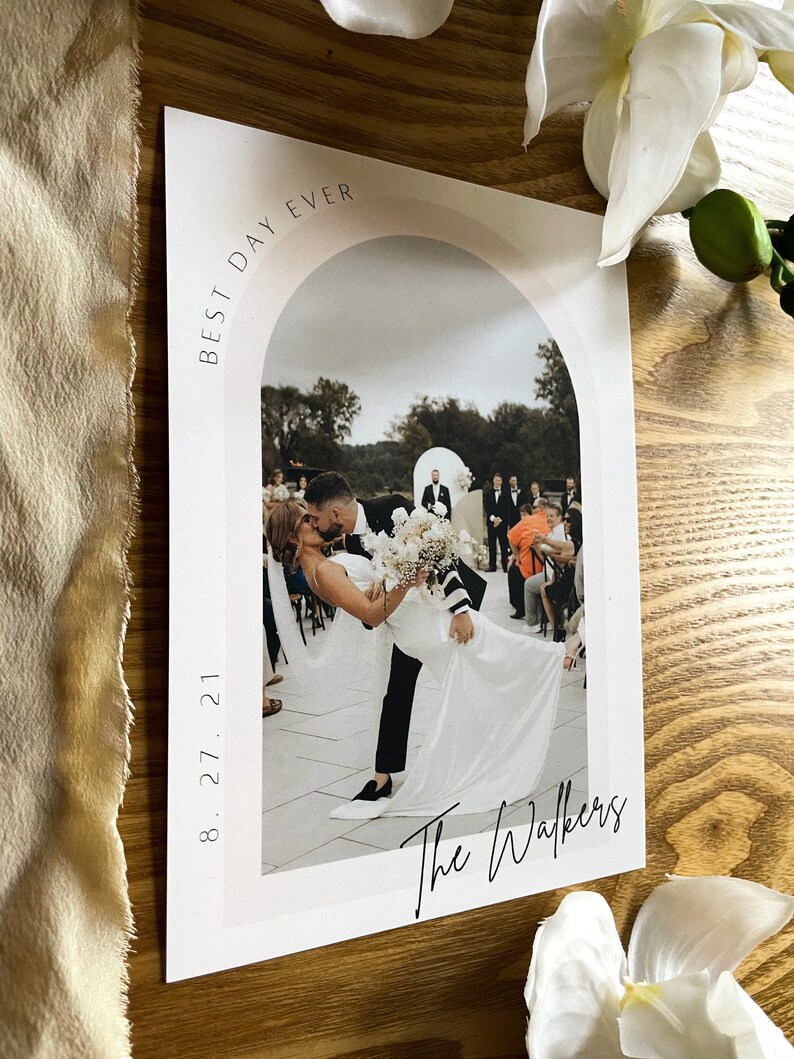 May include: A wedding photo with the couple kissing under an archway. The photo is framed with a white border and has the text "Best Day Ever" and "The Walkers" written on it. The date "8.27.21" is also included.