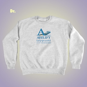 May include: Gray sweatshirt with a blue and white logo that says "ABILIFY (aripiprazole) 2.5, 5, 10, 15, 20, 30 mg Tablets".