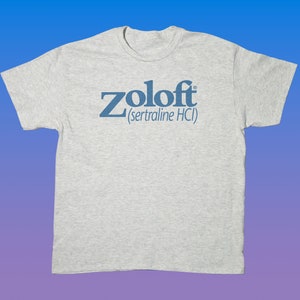 May include: A gray t-shirt with the text "Zoloft (sertraline HCI)" printed in blue.