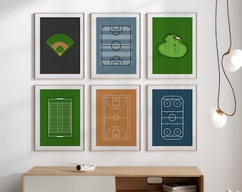 May include: Six framed prints of different sports fields, including baseball, football, golf, basketball, and hockey. The prints are hung on a white wall above a wooden shelf with a white and wood cabinet. A white toy rabbit and a white toy wagon are on the floor in front of the shelf.