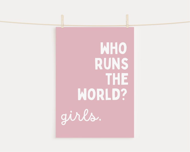 May include: A pink poster with the text "Who runs the world? girls." in white lettering.