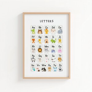 May include: A framed alphabet chart with the word "LETTERS" at the top. Each letter is paired with a cute animal illustration. The animals include a crocodile, bear, dog, elephant, fox, giraffe, lion, and more. The frame is a light brown color.