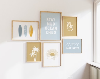 May include: A set of six framed prints with a beach theme. The prints feature images of surfboards, palm trees, a sunset, a peace sign, and the text "Stay Wild Ocean Child" and "Make Waves".