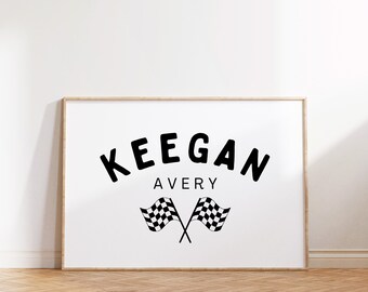 May include: A framed print with the name "KEEGAN AVERY" in black text with a racing flag design.