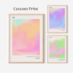 May include: Three framed prints with colorful gradient backgrounds. The top print has the text "Emily" and "Intuitive, Caring, Protective, Cancer". The middle print has the text "111" and "You remind me of the sun, Emma". The bottom print has the text "TITLE 1" and "CAPTION TEXT 2, CAPTION TEXT 3".