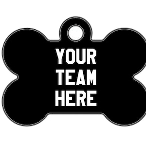 May include: Two black bone-shaped dog tags with white text. The first tag says "YOUR TEAM HERE". The second tag says "CALL MY PEOPLE 555-555-5555".