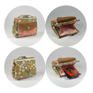 Op de afbeelding: Een kleine groene en roze bloemen portemonnee met een bruine suède klep en een metalen sluiting. De portemonnee is open om een roze voering en een klein vakje aan de binnenkant te laten zien.