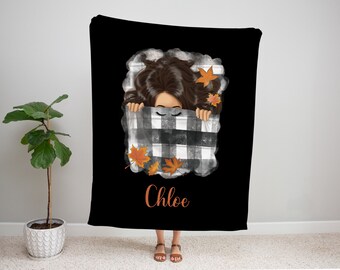 May include: A black and white checkered blanket with orange and brown fall leaves. A woman's face is peeking out from under the blanket. The name "Chloe" is written in orange below the blanket.