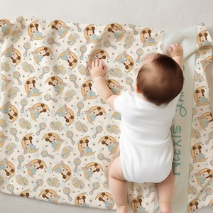 May include: A cream-colored baby blanket with a repeating pattern of Mickey Mouse characters in blue and yellow. The blanket has a green border with the name "Alexis" written vertically on the side.
