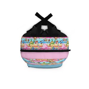 May include: A black backpack with a colorful pattern of characters from the Toy Story movie franchise. The pattern includes Woody, Buzz Lightyear, Jessie, and other characters. The backpack has a pink and blue striped design.